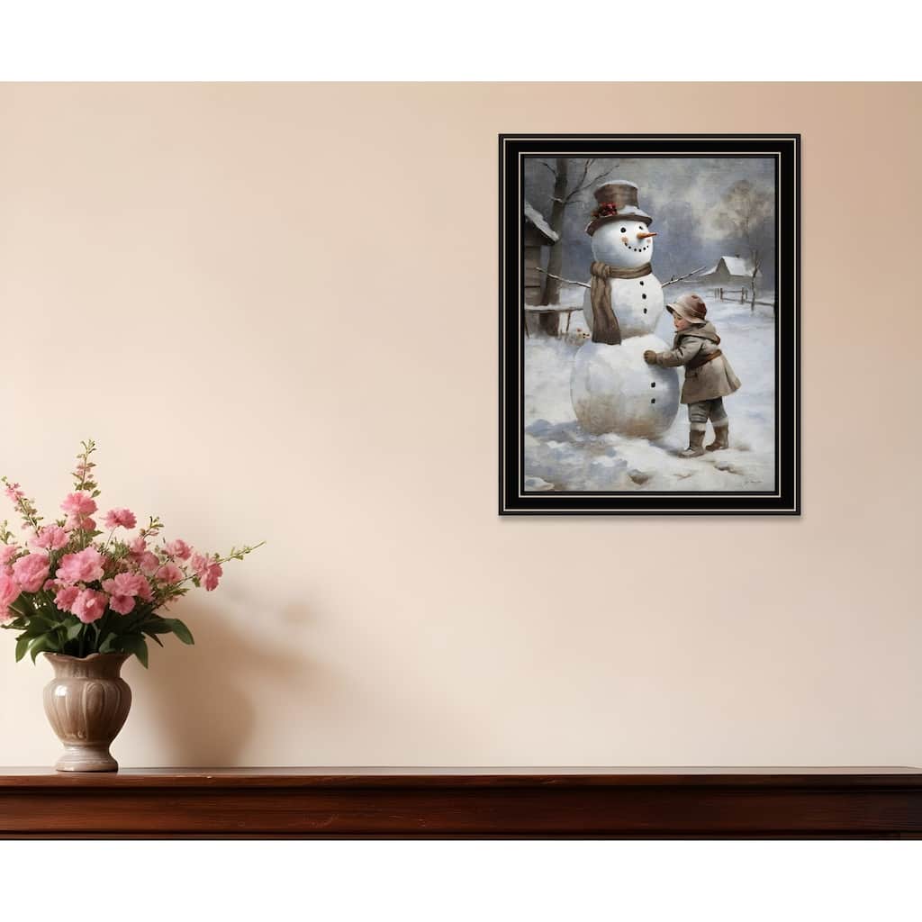 HomeRoots Boy Building A Snowman Black Framed Wall Art