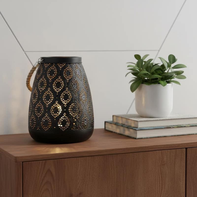 HomeRoots 8" Black Metal Battery Operated Pierced Geometric Lantern - 6.30 in. x 7.87 in. x 6.30 in. - Black - 6.30 in. x 7.87 in. x 6.30 in.