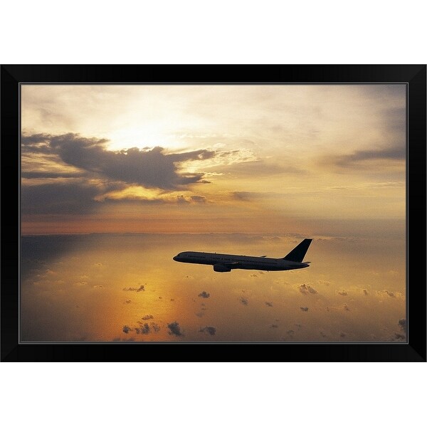 "Commercial Aeroplane Flying Above the Sea at Dusk" Black Framed Print