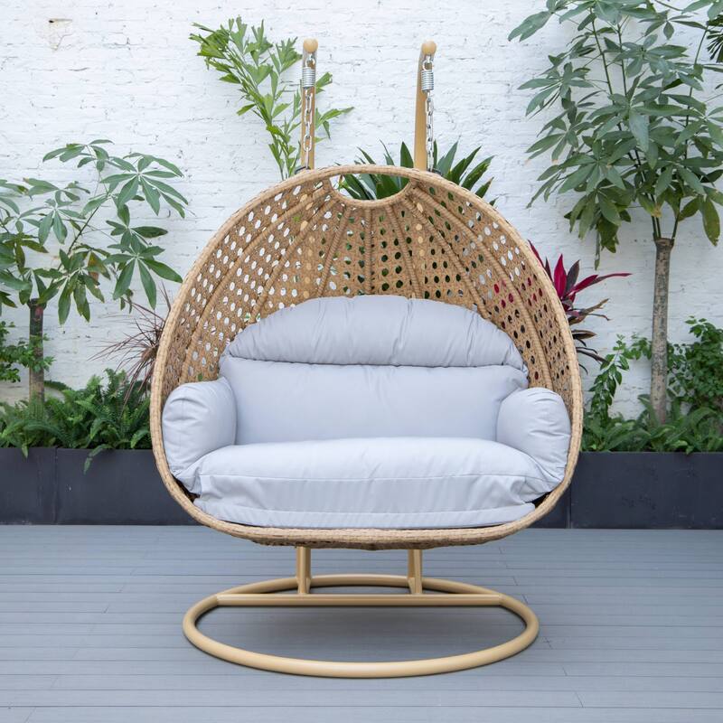 LeisureMod Mendoza 2-Person Hanging Egg Swing Chair - Handcrafted Light Brown Wicker, Patio Hammock Lounger with Cushions - 53"