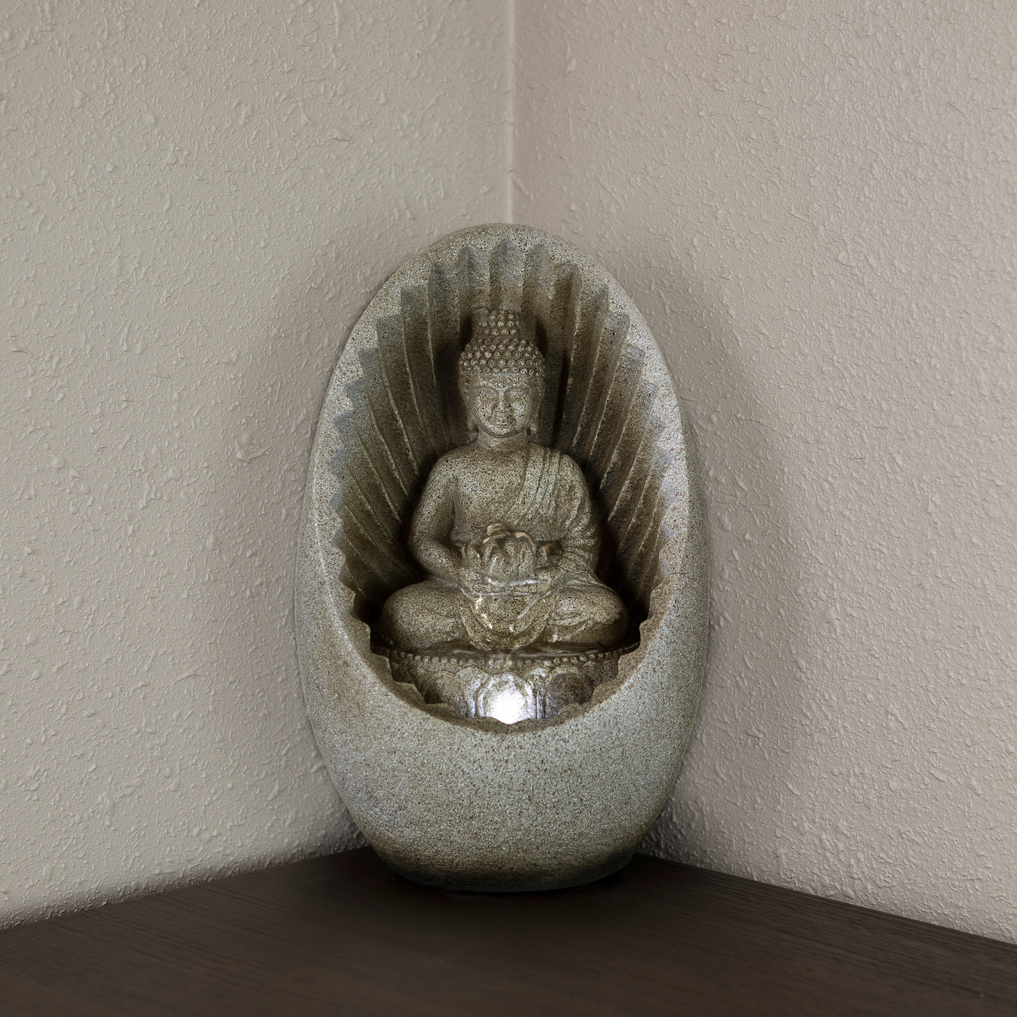 resin meditating buddha on column patio fountain with led light