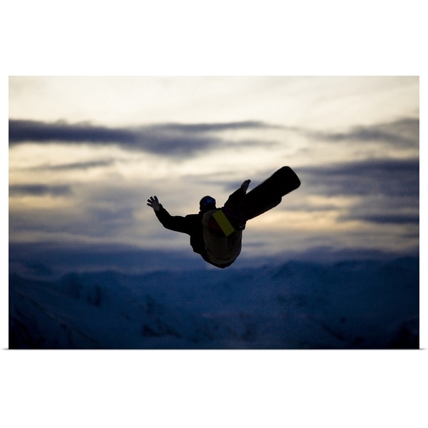 "A male snowboarder does a back flip while riding at a snow park in Wanaka, New Zealand." Poster Print