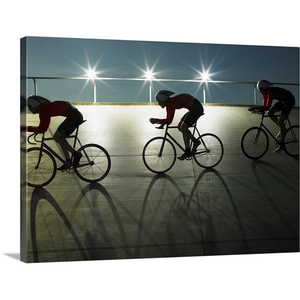 "Cyclists on velodrome track at night, side view" Canvas Wall Art