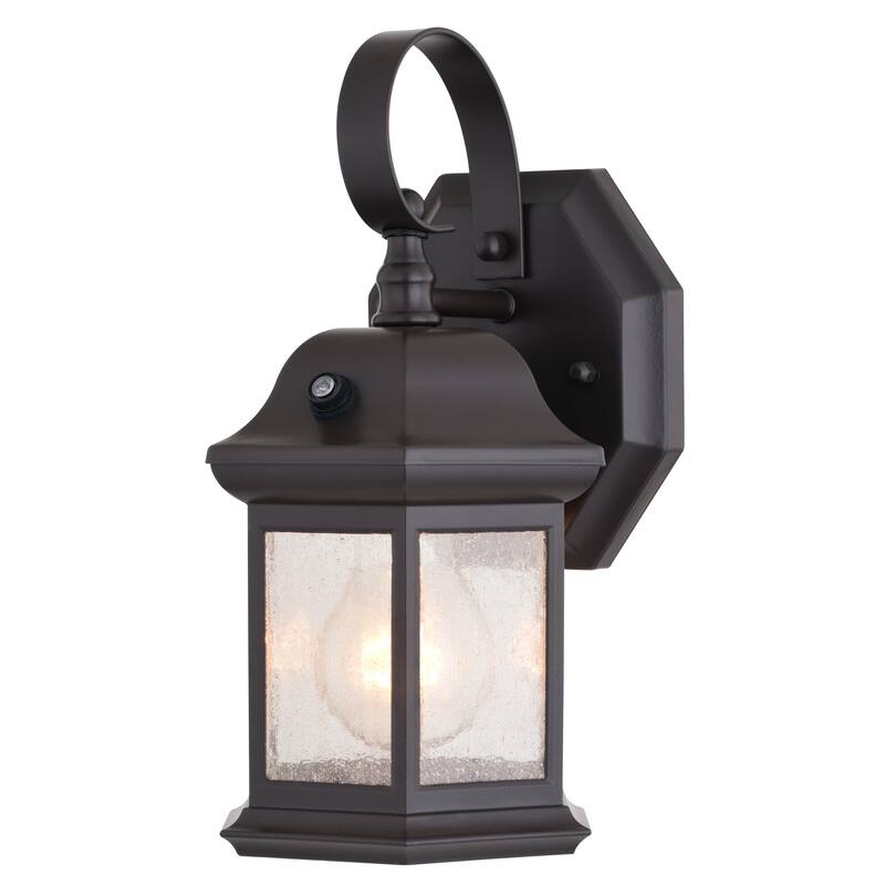 VAXCEL Wellington 1-Light Med Bronze Dusk to Dawn Sensor Outdoor Wall Sconce, Rust-Resistant Aluminum, Clear Seeded Glass Shade