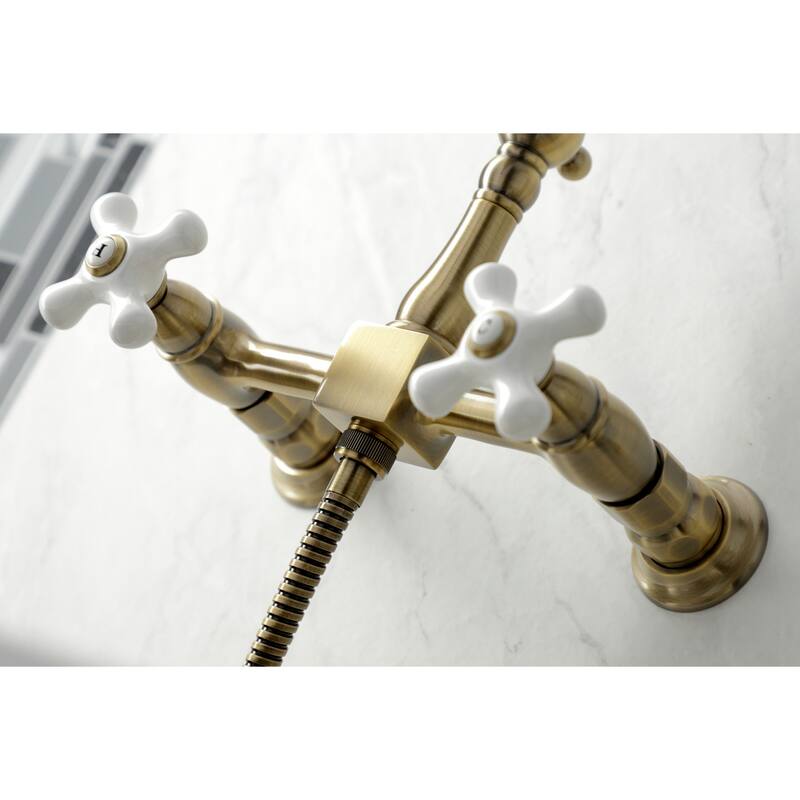 Kingston Brass Heritage Wall Mount Bridge Kitchen Faucet with Brass Sprayer