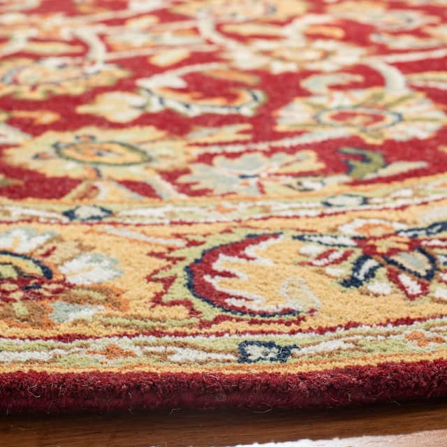 SAFAVIEH Handmade Classic Clotilda Traditional Oriental Wool Rug - 4'6" x 6'6" Oval - Red/Gold