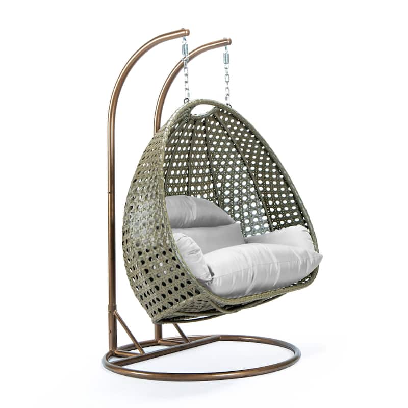 LeisureMod 2-Person Hanging Egg Swing Chair with Metal Stand - Handcrafted Beige Wicker, Patio Hammock Lounger with Cushions
