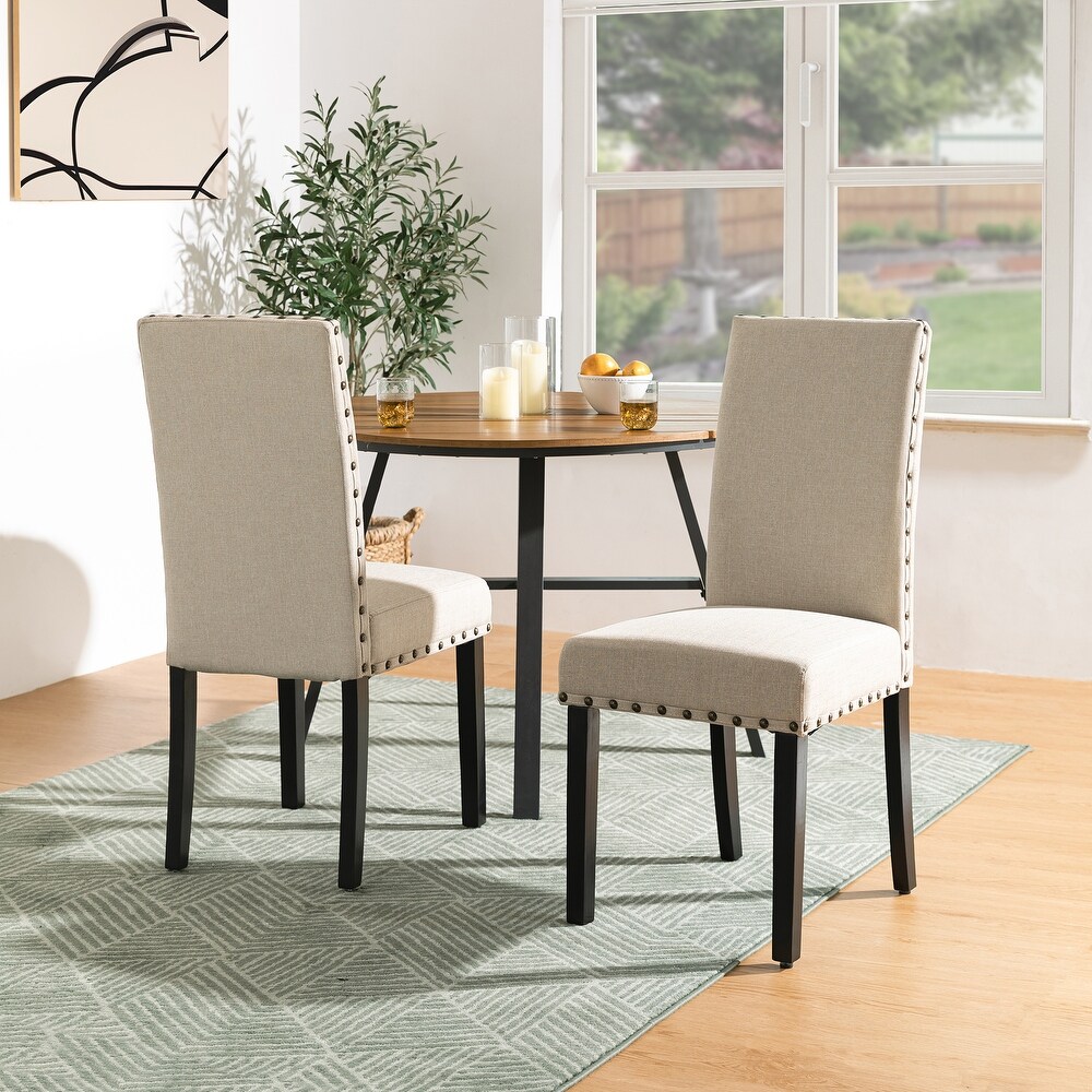Beige dining 2025 chairs with nailheads