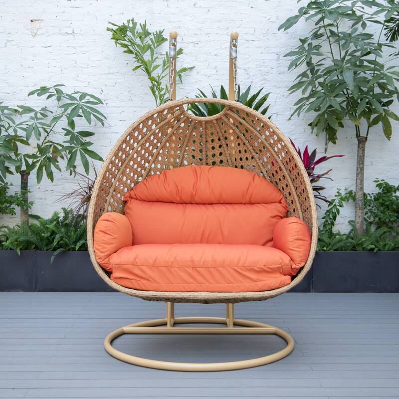 LeisureMod Mendoza 2-Person Hanging Egg Swing Chair - Handcrafted Light Brown Wicker, Patio Hammock Lounger with Cushions - 53"