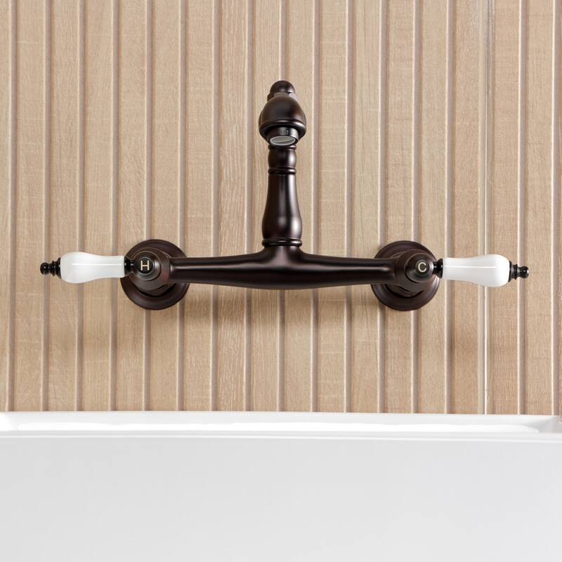 Kingston Brass English Country Two-Handle 2-Hole Wall Mount Bathroom Faucet