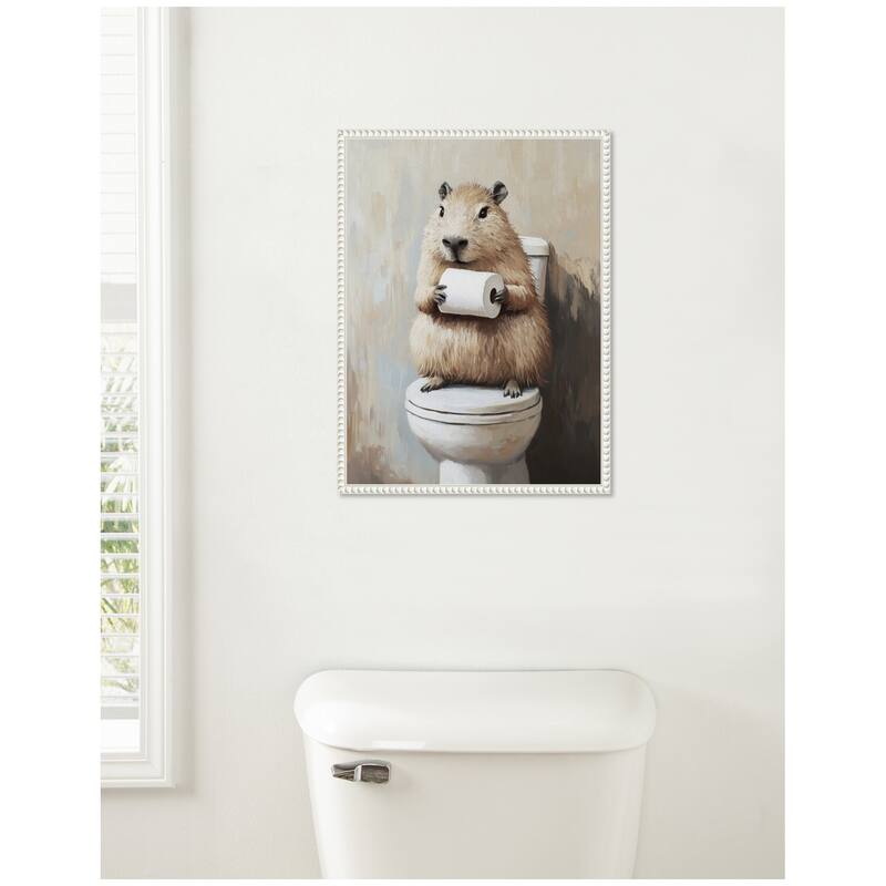 Kate and Laurel Sylvie Capybara Angled Holding Toilet Paper Roll Toilet Bathroom Art Framed Canvas by The Creative Bunch Studio