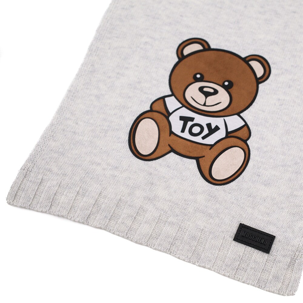 grey teddy bear with patches