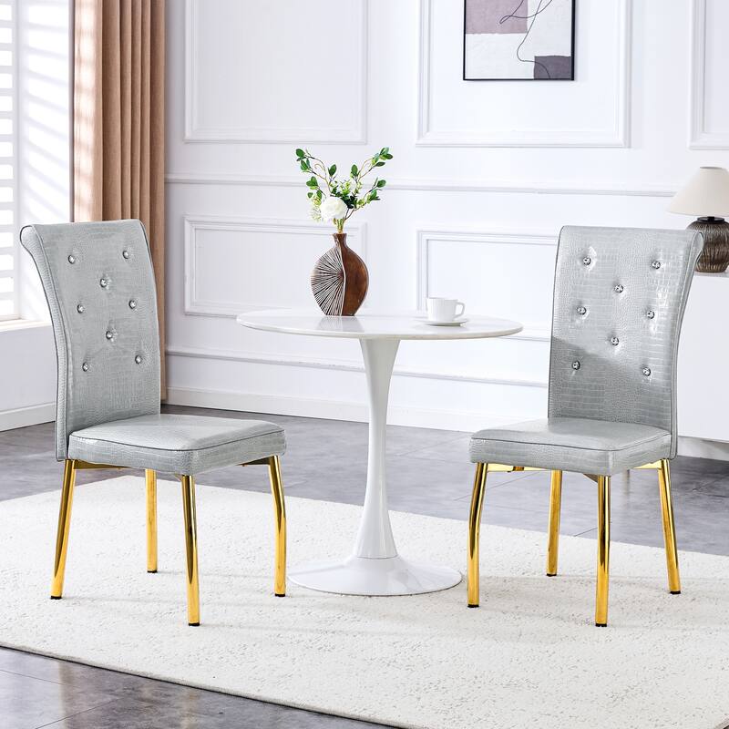 A set of 4 white and black vintage crocodile leather cushioned dining chairs, featuring crystal clasp design and leather