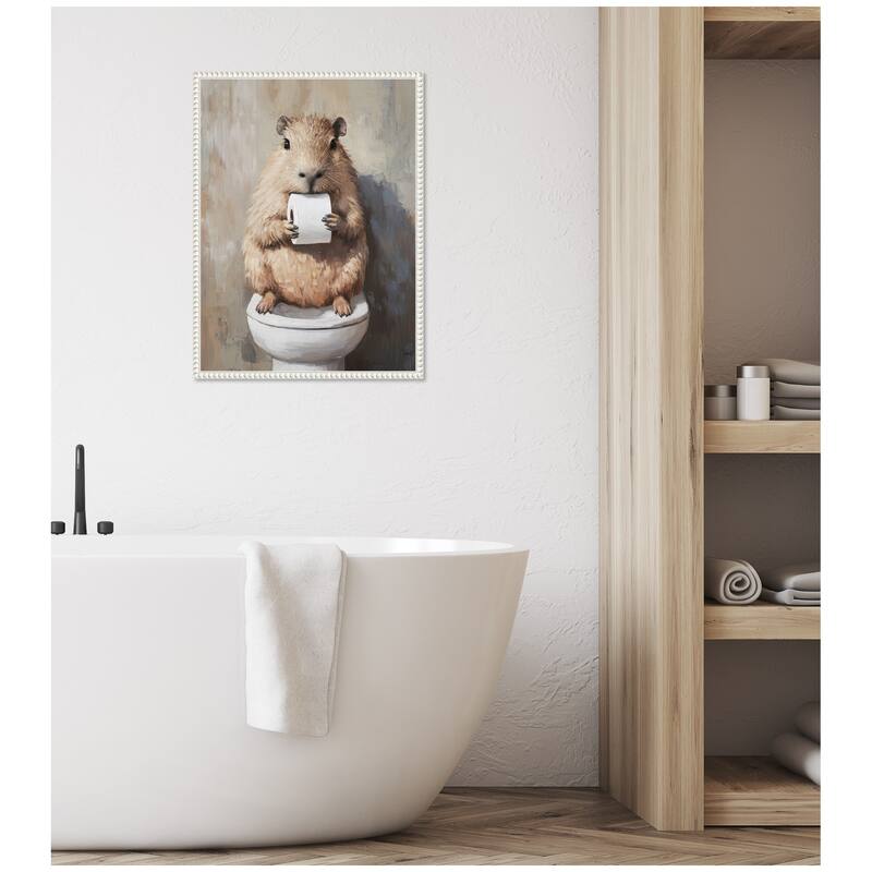 Kate and Laurel Sylvie Capybara Holding Toilet Paper Roll Toilet Bathroom Art Framed Canvas by The Creative Bunch Studio