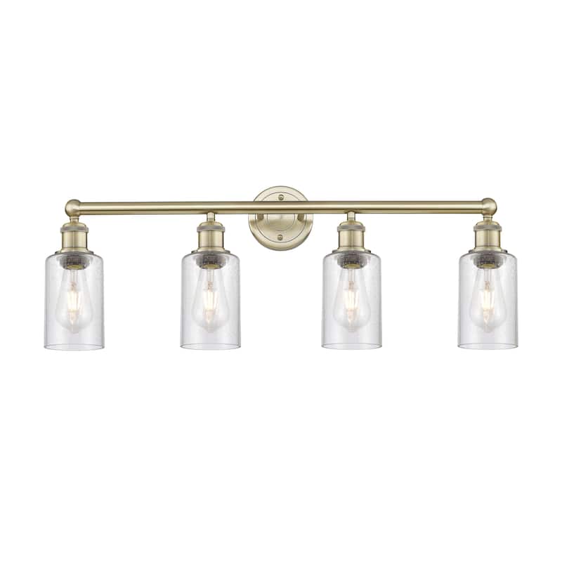 Innovations Lighting Clymer - 4 Light 31" Bath Vanity Light - Antique Brass/Seedy