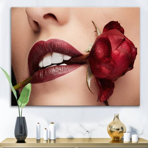 Designart 'Woman With Red Lipstick Holding A Rose In Mouth' Modern Canvas Wall Art Print