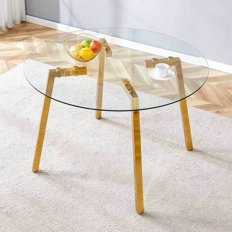 A glass tabletop with a diameter of 40 inches and a modern minimalist circular dining table with gold plated metal legs