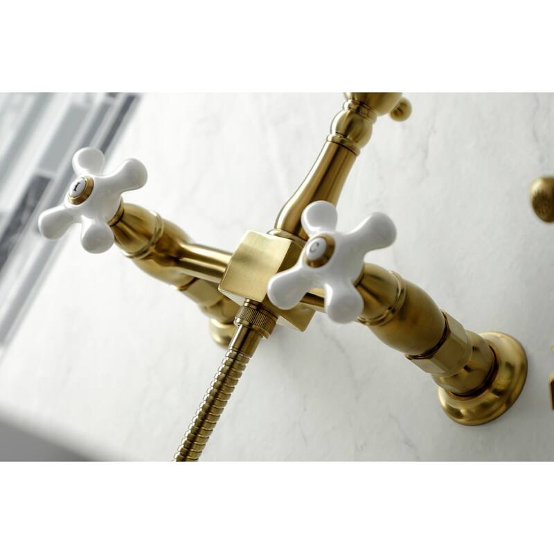 Kingston Brass Heritage Wall Mount Bridge Kitchen Faucet with Brass Sprayer