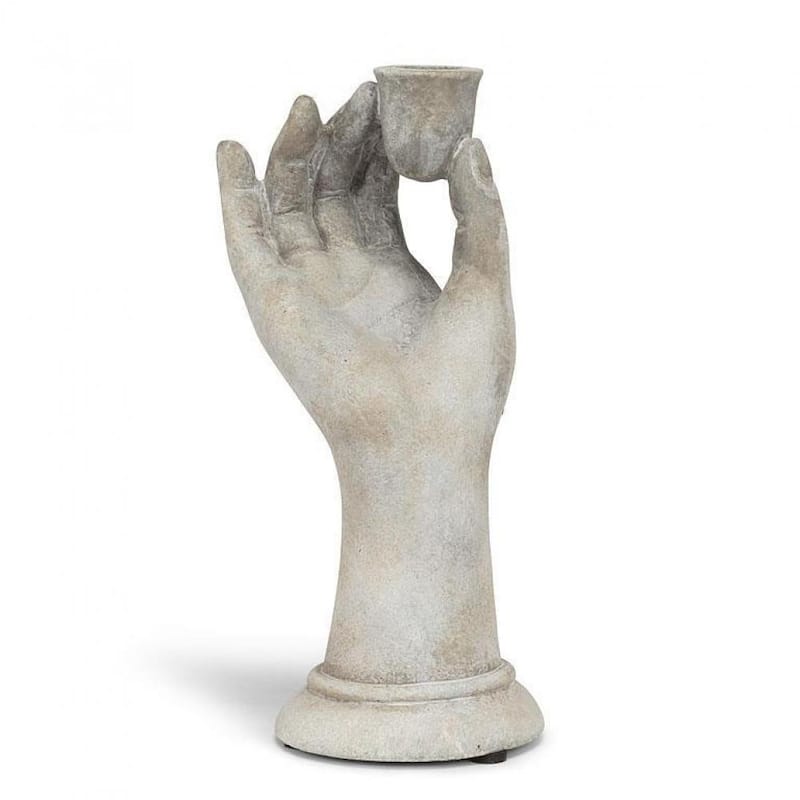 Raised Hand Holding A Taper Candle Holder