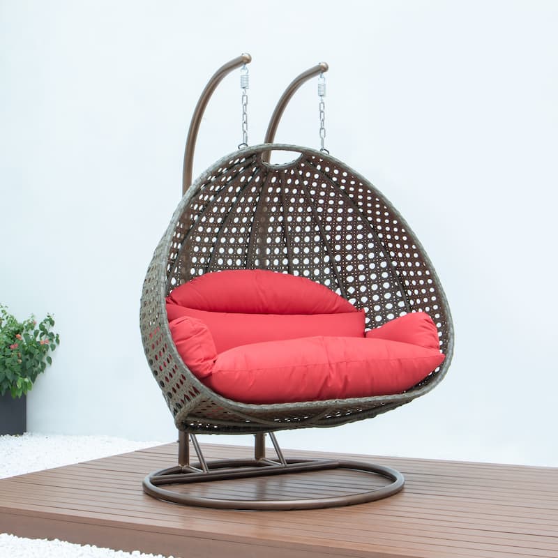LeisureMod 2-Person Hanging Egg Swing Chair with Metal Stand - Handcrafted Beige Wicker, Patio Hammock Lounger with Cushions
