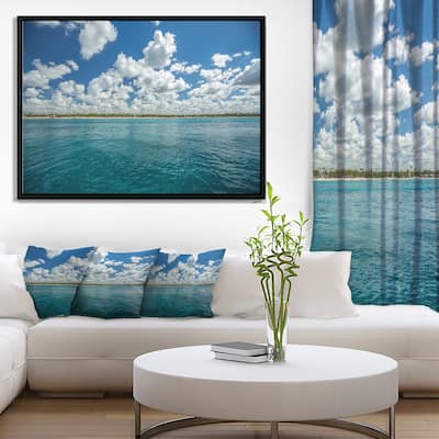 Designart "White Fluffy Clouds Over Sea" Oversized Beach Framed Canvas Artwork Print