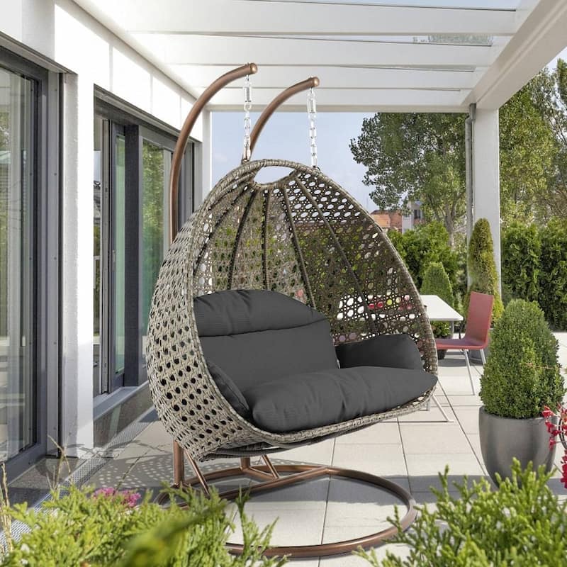 LeisureMod 2-Person Hanging Egg Swing Chair with Metal Stand - Handcrafted Beige Wicker, Patio Hammock Lounger with Cushions - Dark Grey