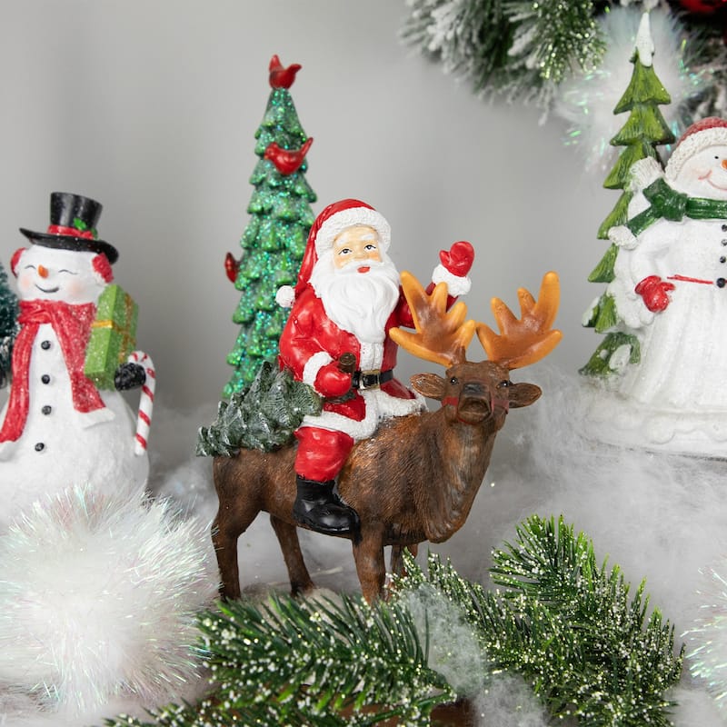 Santa Claus on a Reindeer Holding a Frosted Pine Tree Christmas Figurine - 8.25"