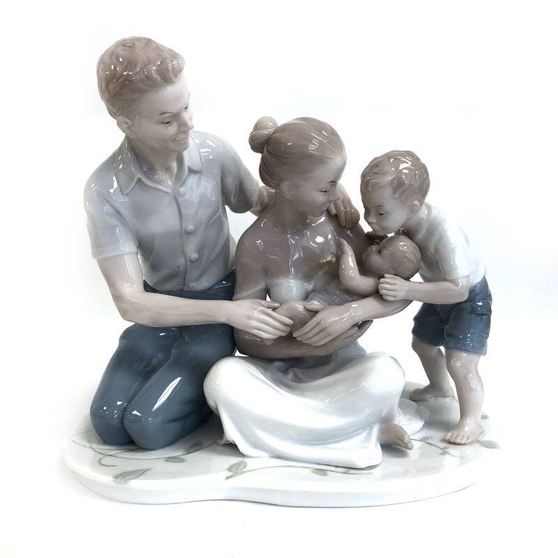 Mother, Father And Son Welcoming The New Baby Figurine