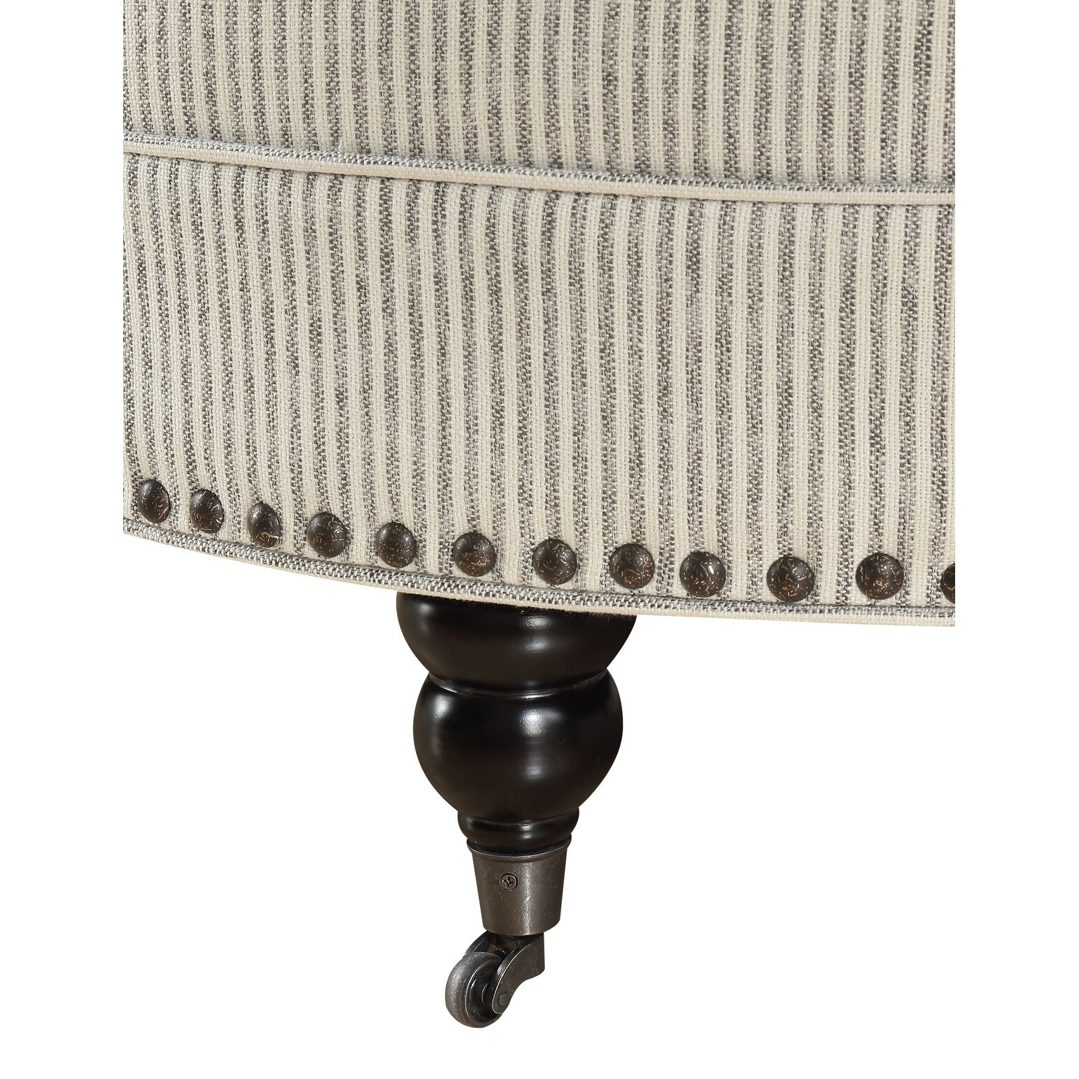 Detail view of the nailhead trim and turned leg of the Brewster ottoman.