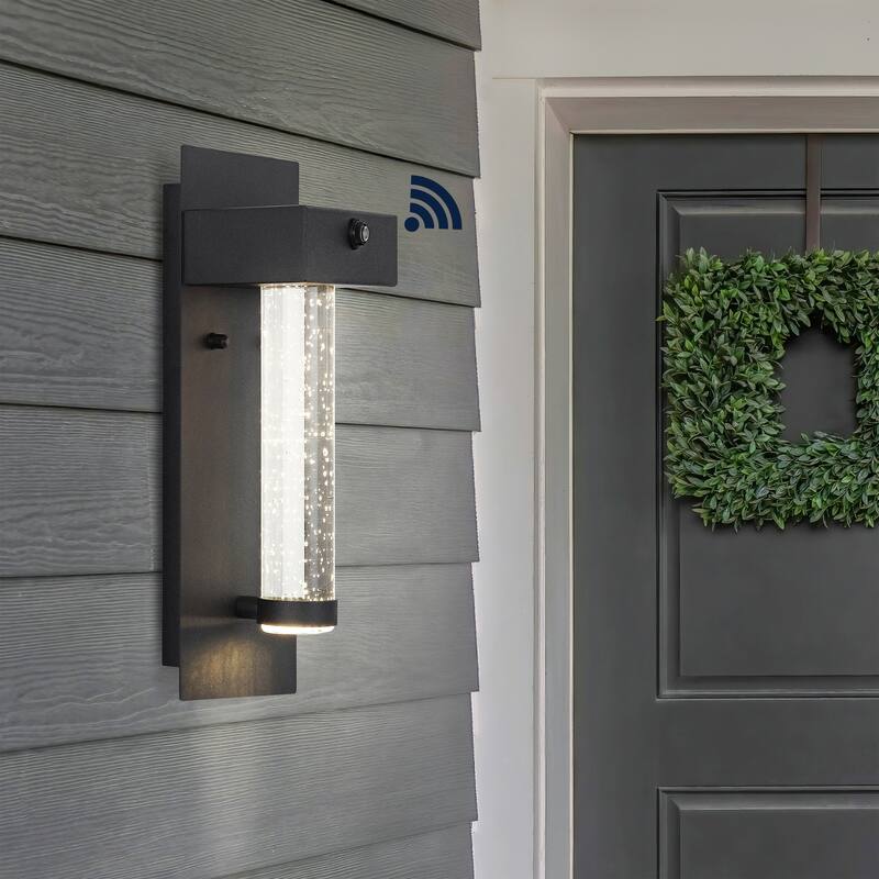 Juno 5.5" 1-Light Minimalist Iron/Seeded Glass with Dusk-to-Dawn Sensor Integrated LED Outdoor Sconce, Black by JONATHAN Y - 5.5