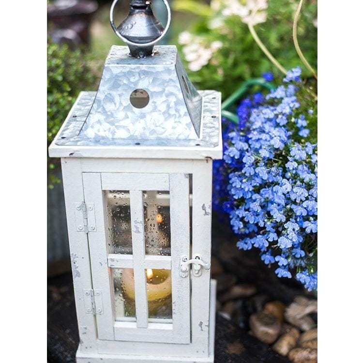 https://ak1.ostkcdn.com/images/products/is/images/direct/99b76e8bbbf34f419ff90459f5a8ed5bc47e4629/RusticReach-Lantern-House-Candle-Holder-in-White.jpg