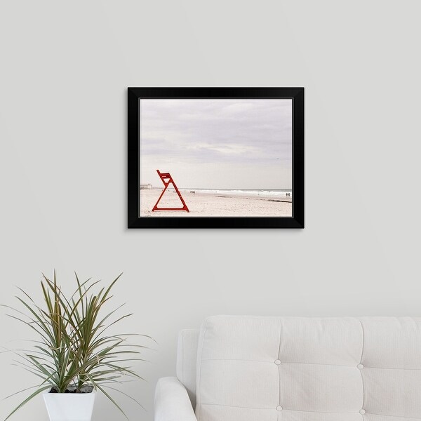 "Red life guard chair on beach" Black Framed Print