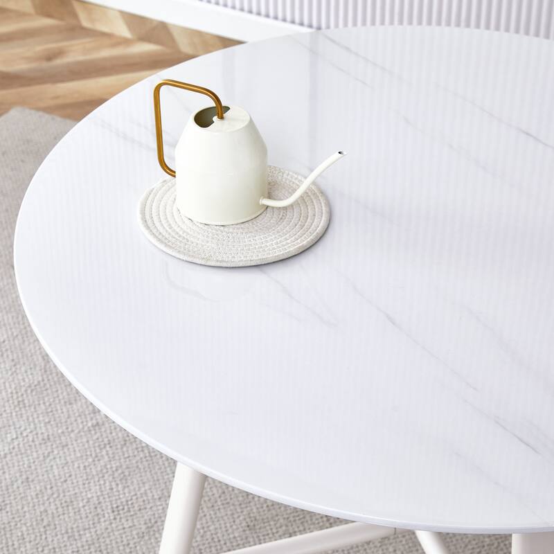 A Modern Minimalist Circular Dining Table With A 42 Inch Diameter White Patterned Tabletop And White Metal Legs