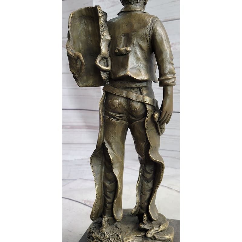 Country Western Cowboy In Chaps Carrying Imitative Horse Saddle Bronze Statue Sculpture Figure 12 Inches X 4 Inches
