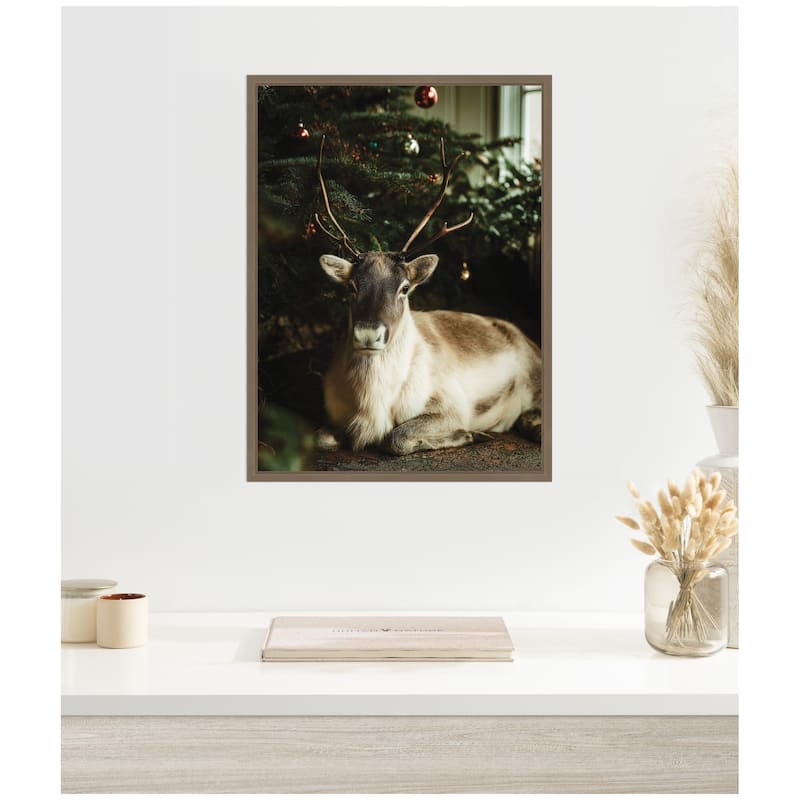 Kate and Laurel Sylvie Framed Canvas Reindeer Sitting Under a Christmas Tree by Michael Schauer
