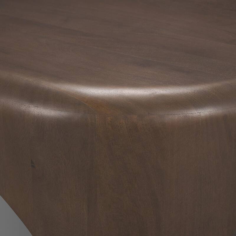 The Shima Coffee Table is a smooth, dark matte brown oval coffee table with curved edges and arched cut out legs.