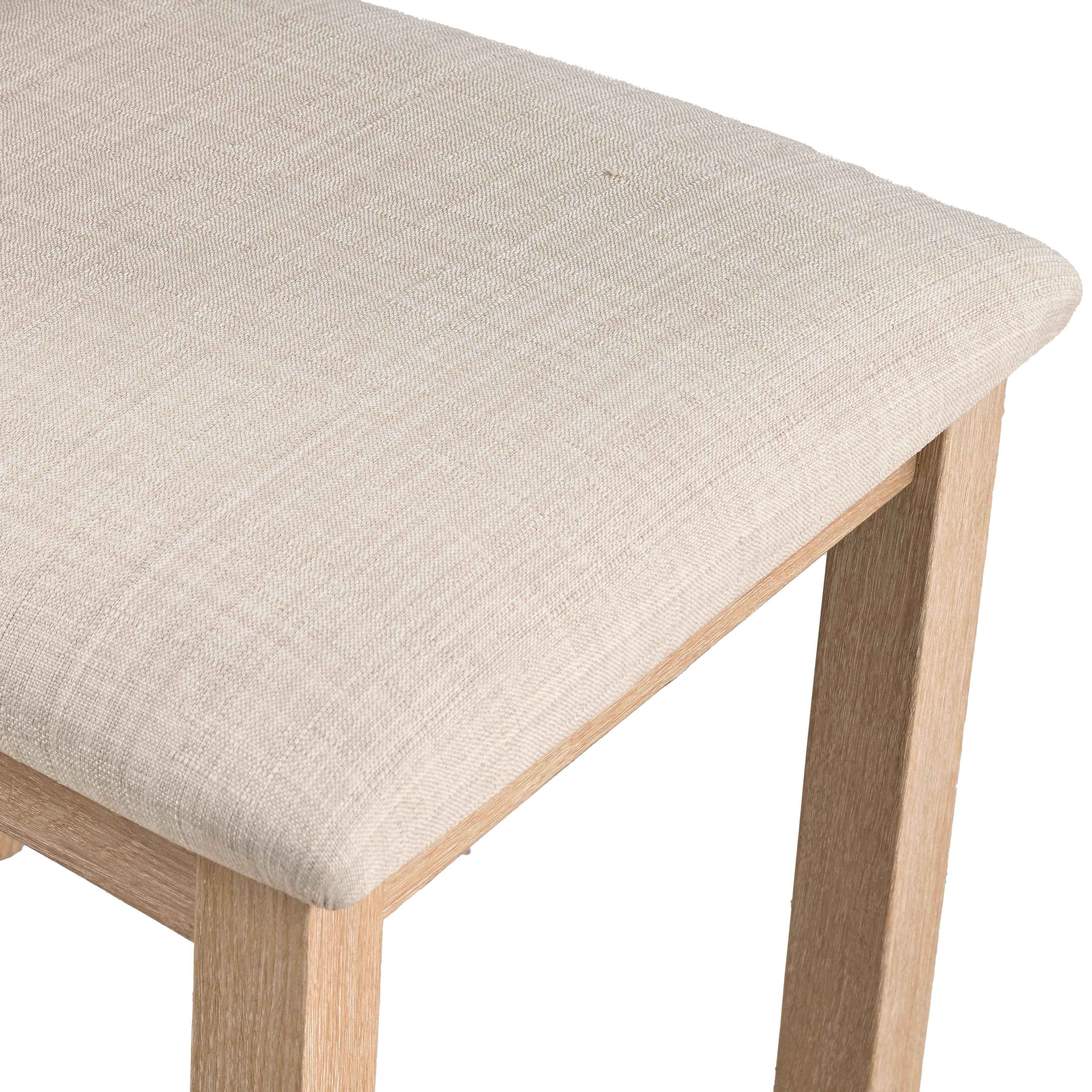 Close-up of the beige fabric seat on a dining chair.