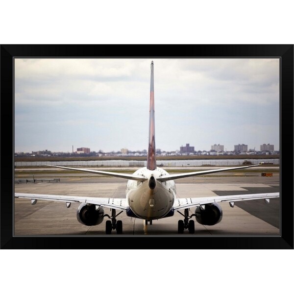 "Rearview of an airplane on a runway" Black Framed Print