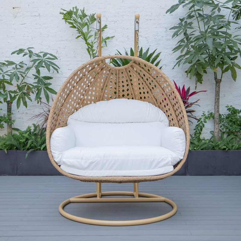 LeisureMod Mendoza 2-Person Hanging Egg Swing Chair - Handcrafted Light Brown Wicker, Patio Hammock Lounger with Cushions - 53"