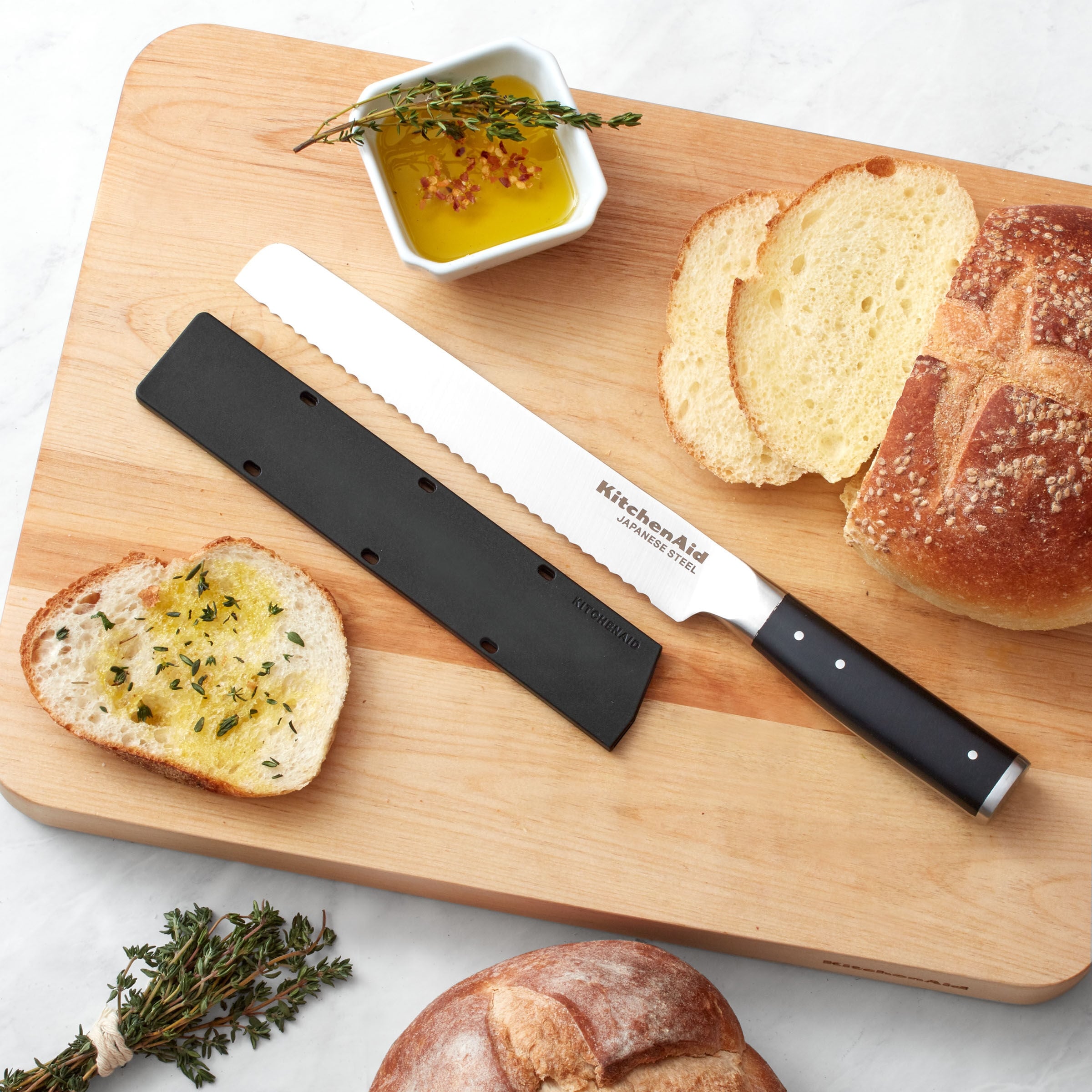 https://ak1.ostkcdn.com/images/products/is/images/direct/a31a81c3b2e843a8ea97f6fb3423fcef12c2e48a/KitchenAid-Gourmet-Forged-Bread-Knife%2C-8-Inch%2C-Black.jpg
