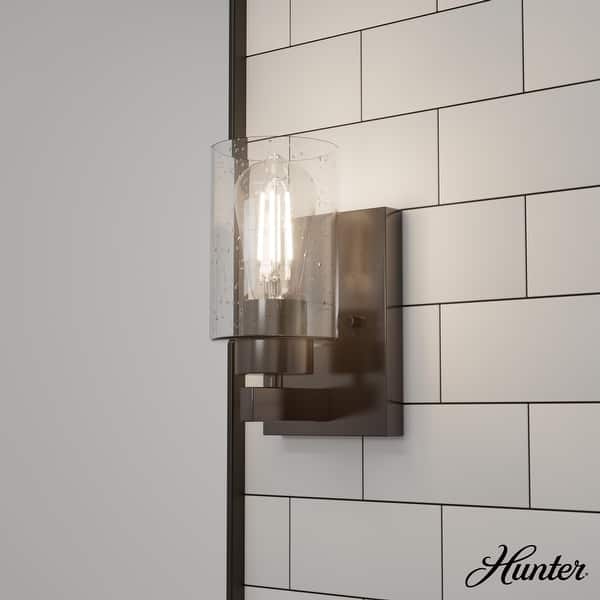 slide 2 of 3, Hunter Hartland 1 Light Wall Sconce - Hallway, Bathroom, Bedside - Round, Clear Seeded Glass - Modern, Transitional - Damp-Rated Noble Bronze