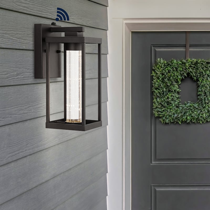 Justina 4.75" 1-Light Industrial Iron/Seeded Glass with Dusk-to-Dawn Sensor Integrated LED Outdoor Sconce, Black by JONATHAN Y