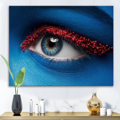 Designart 'Female Eye With Blue Paint On Face & Red Balls' Modern Canvas Wall Art Print