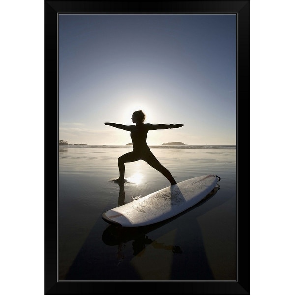 "silhouette of female surfer doing warrior yoga pose" Black Framed Print