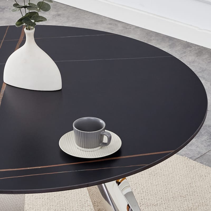 A 42-Inch Round Table with Stainless Steel Legs and a Marble Top, Perfect for 4 to 6 People.