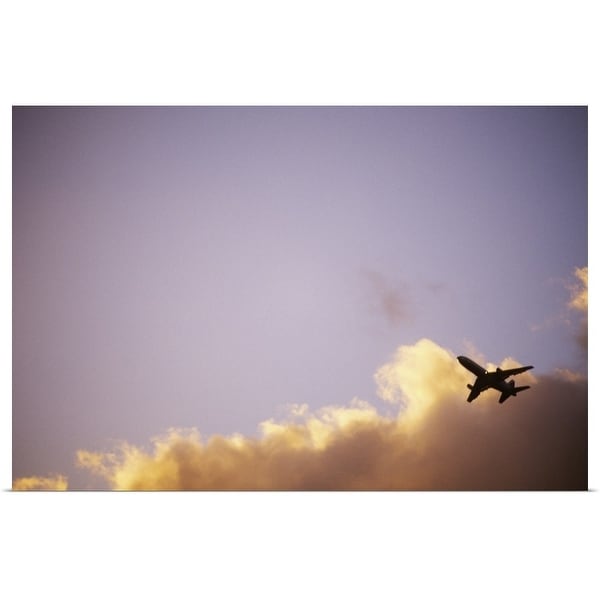 "Airplane soars through blue sky and clouds at sunset." Poster Print