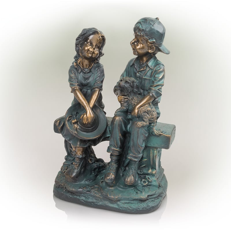 Girl and Boy Sitting on Bench with Puppy Statue