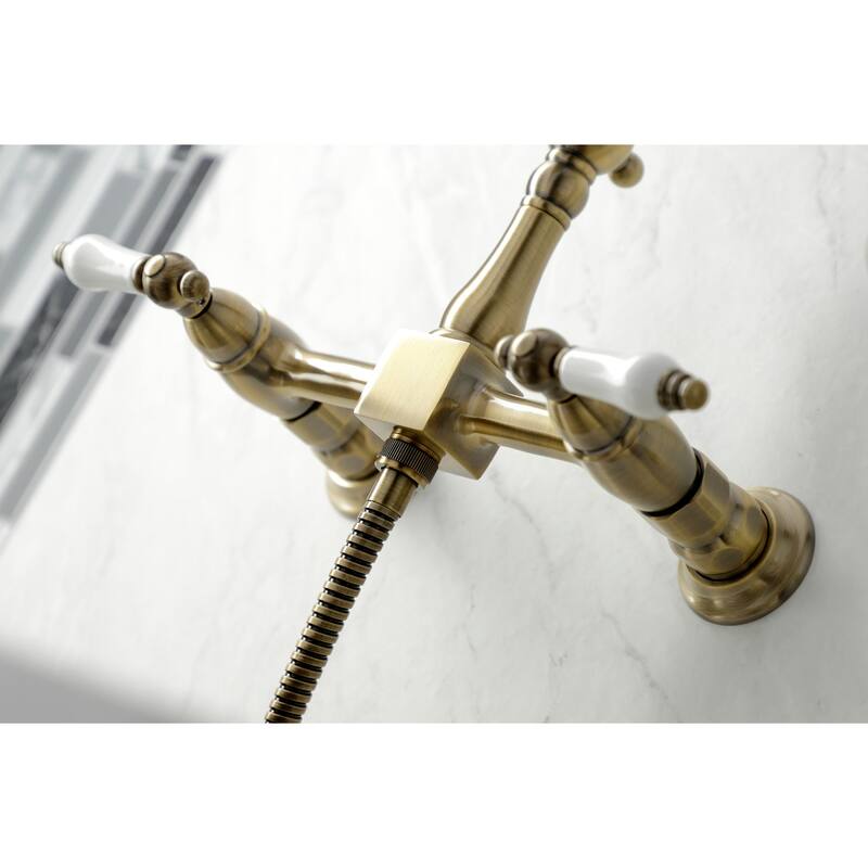 Kingston Brass Heritage Wall Mount Bridge Kitchen Faucet with Brass Sprayer