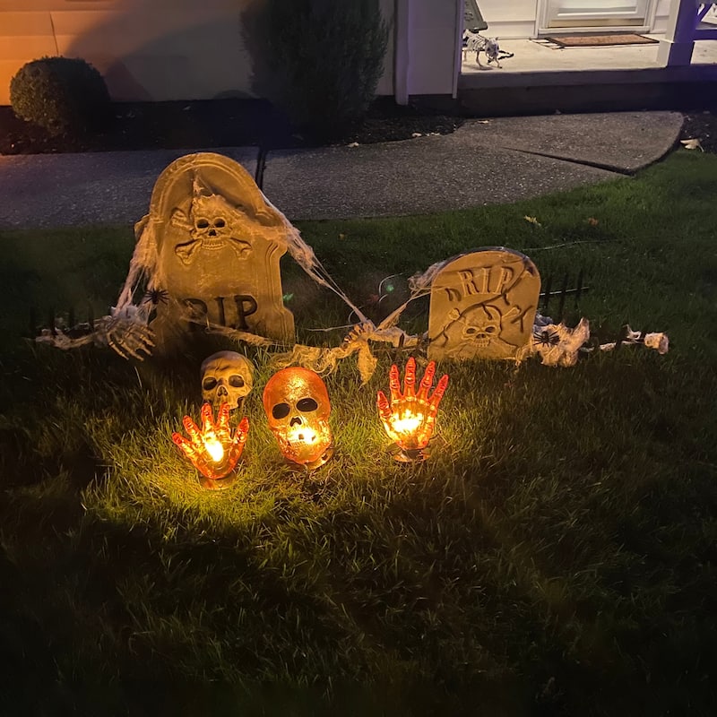 8.5" Lighted Orange Skull and Hands Outdoor Halloween Decoration - 4ft Black Wire