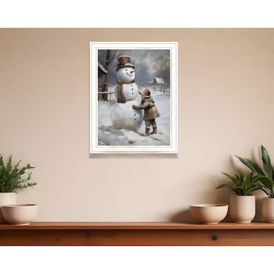 HomeRoots Boy Building A Snowman White Framed Wall Art